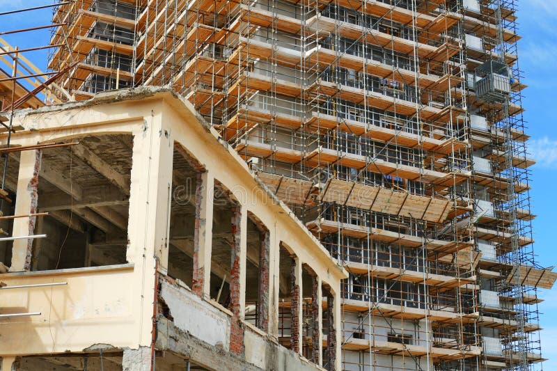 new residential building under construction on a dismissed industrial area view from below. new residential building under construction on a dismissed industrial area view from below