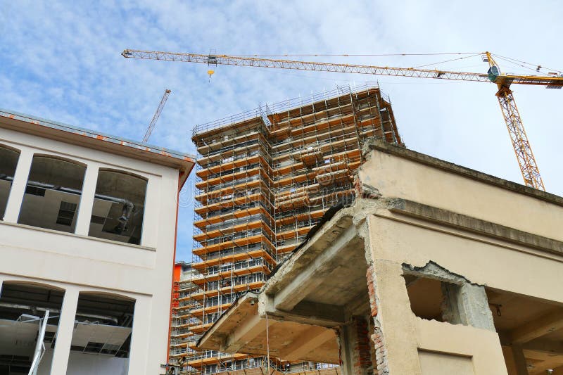 new residential building under construction on a dismissed industrial area view from below. new residential building under construction on a dismissed industrial area view from below