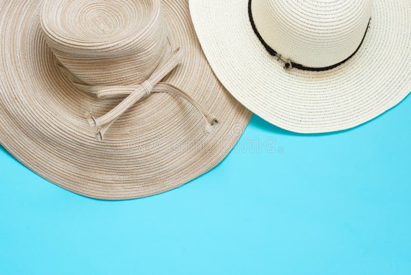 Various broad brimmed women`s straw hats on light mint blue background. Summer vacation fashion accessories beach party concept. Top view flat lay. Minimalist elegant style. Copy space. Various broad brimmed women`s straw hats on light mint blue background. Summer vacation fashion accessories beach party concept. Top view flat lay. Minimalist elegant style. Copy space