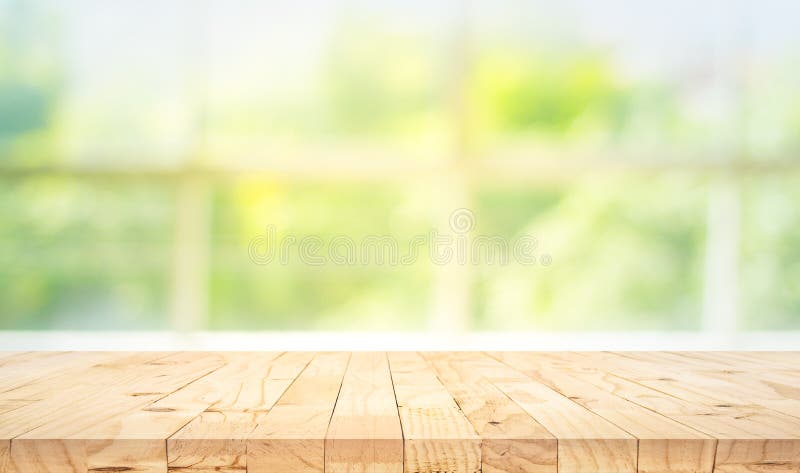 Empty wood table top on blur abstract green garden from window view in the morning. For montage product display or design key visual layout. Empty wood table top on blur abstract green garden from window view in the morning. For montage product display or design key visual layout