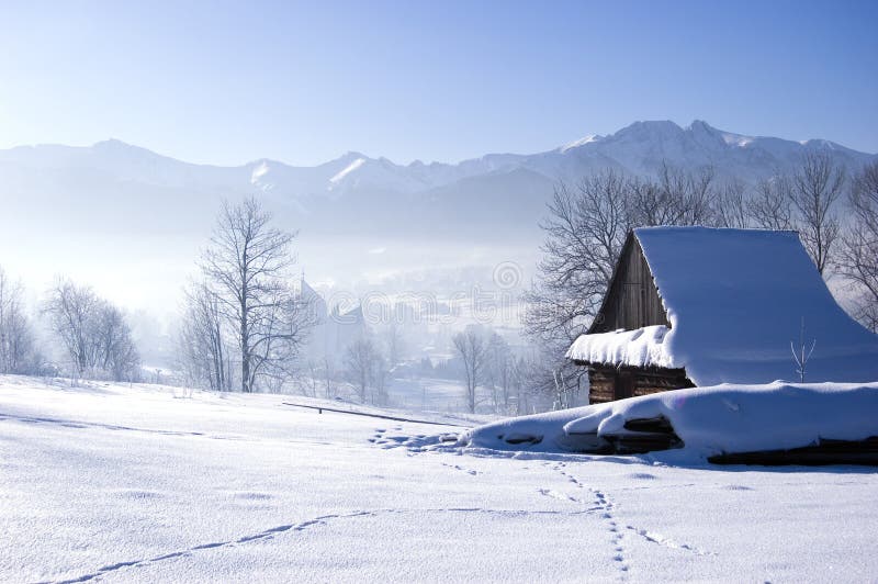 Winter scene in mountains. Old house and snow. Winter scene in mountains. Old house and snow