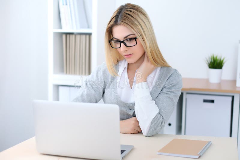坐在有便携式计算机的办公室工作场所的年轻女商人或学生女孩 家庭企业概念 图库摄影 坐在有便携式计算机的办公室工作场所的年轻女商人或学生女孩 家庭企业概念 图库摄影