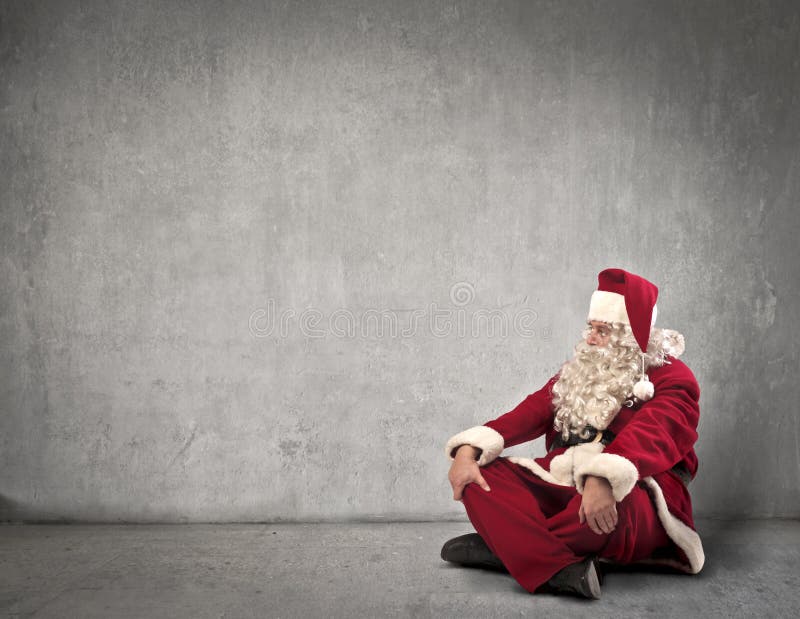 Santa Claus sitting near a dark white wall. Santa Claus sitting near a dark white wall