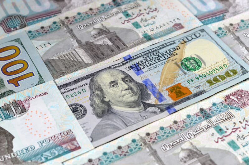 Egyptian money banknotes of 100 EGP LE one hundred pounds bill and USD American cash of 100 dollars, money exchange rates of Egypt and United states of America, inflation and economy concept. Egyptian money banknotes of 100 EGP LE one hundred pounds bill and USD American cash of 100 dollars, money exchange rates of Egypt and United states of America, inflation and economy concept