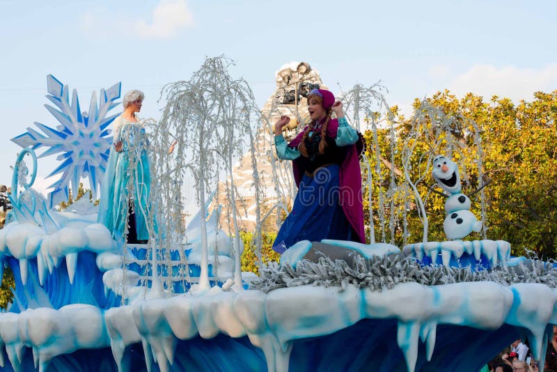 Elsa and Anna as well as Olaf from the popular computer-animated musical fantasy-comedy are waving atop a beautiful blue and white snowy float in Disneyland's A Christmas Fantasy Parade. Very popular Christmastime parade at Disneyland. Elsa and Anna as well as Olaf from the popular computer-animated musical fantasy-comedy are waving atop a beautiful blue and white snowy float in Disneyland's A Christmas Fantasy Parade. Very popular Christmastime parade at Disneyland.