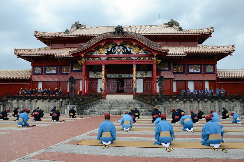 The men sit side by side in a row and pray King and Queen during Shuri castle's event of new year celebration in Okinawa, Japan. The men sit side by side in a row and pray King and Queen during Shuri castle's event of new year celebration in Okinawa, Japan.