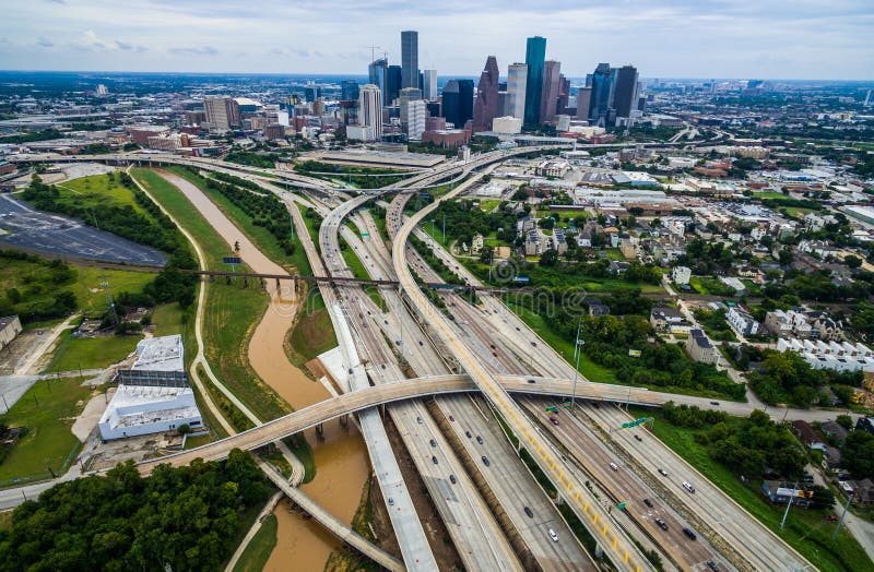 Urban Sprawl Bridge and Overpasses High Aerial Drone view over Houston Texas Urban Highway view High Aerial Drone view over Houston Texas Buffalo Bayou River over interstates and highways with the cityscape in the background. Urban Sprawl Bridge and Overpasses High Aerial Drone view over Houston Texas Urban Highway view High Aerial Drone view over Houston Texas Buffalo Bayou River over interstates and highways with the cityscape in the background.