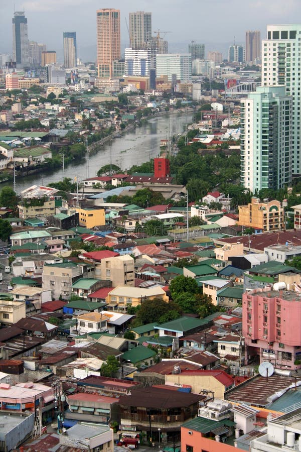 crowded urban sprawl of Makati city in manila along the banks of the pasig river in the philippines. crowded urban sprawl of Makati city in manila along the banks of the pasig river in the philippines