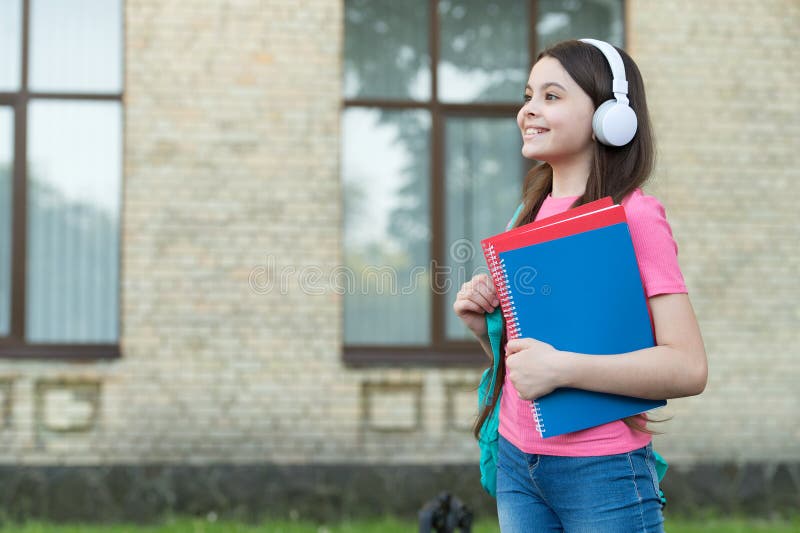 Teen girl school student with stereo headphones new technology, according to nowadays concept. Teen girl school student with stereo headphones new technology, according to nowadays concept.