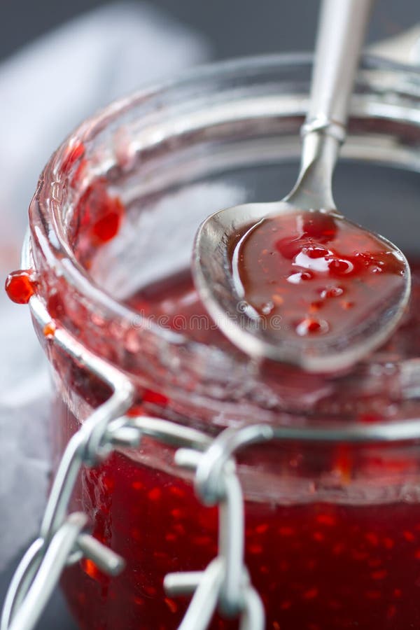 Jar of raspberry jam,shallow focus. Jar of raspberry jam,shallow focus