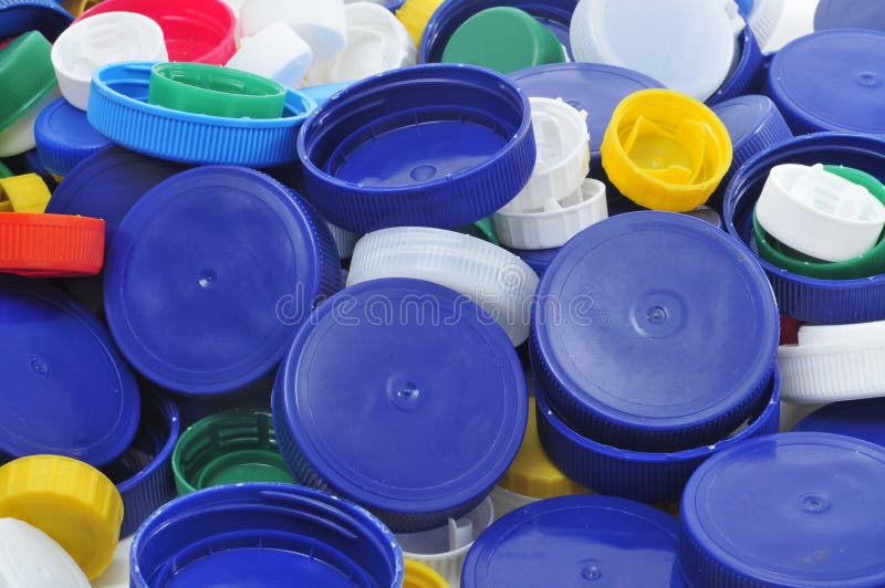 Closeup of a pile of plastic caps of different colors and sizes. Closeup of a pile of plastic caps of different colors and sizes