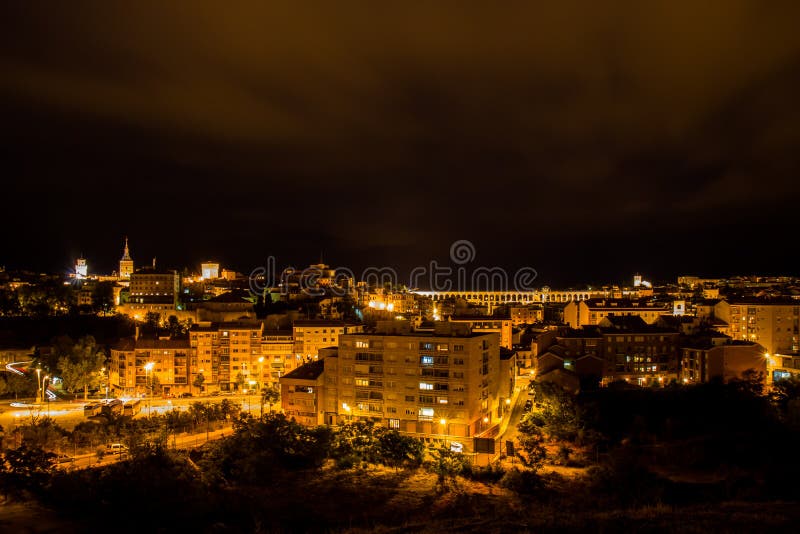 A view on the ancient Roman Segovia Aqueduct in Spanish Castilla y León from the mirador de la Piedad with her stone crosses. The aqueduct bridge is a Roman aqueduct and one of the best-preserved elevated Roman aqueducts and the foremost symbol of Segovia, as evidenced by its presence on the city`s coat of arms. The aqueduct is built of unmortared, brick-like granite blocks and once transported water from the Rio Frio river, situated in mountains 17 km 11 mi from the city in the La Acebeda region. A view on the ancient Roman Segovia Aqueduct in Spanish Castilla y León from the mirador de la Piedad with her stone crosses. The aqueduct bridge is a Roman aqueduct and one of the best-preserved elevated Roman aqueducts and the foremost symbol of Segovia, as evidenced by its presence on the city`s coat of arms. The aqueduct is built of unmortared, brick-like granite blocks and once transported water from the Rio Frio river, situated in mountains 17 km 11 mi from the city in the La Acebeda region.