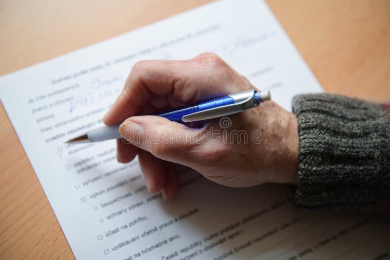 Man filling in form for trips outside the district in Czech Republic- signature - March 2. 2021. Man filling in form for trips outside the district in Czech Republic- signature - March 2. 2021