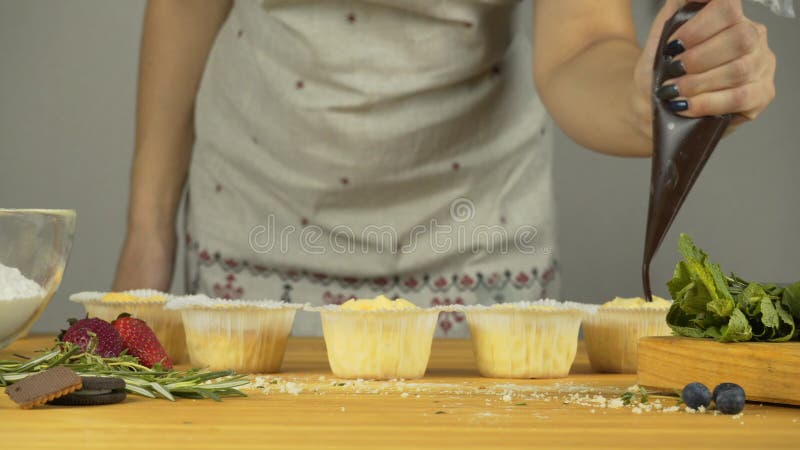 增加装填 与奶油和充塞的杯形蛋糕