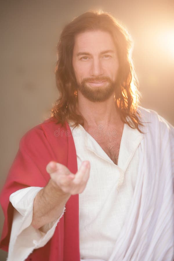 Jesus Christ portrait image back lit with very compassionate eyes filled with love and kindness. His hand is extends in invitation. Jesus Christ portrait image back lit with very compassionate eyes filled with love and kindness. His hand is extends in invitation