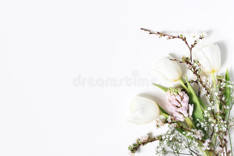 Easter floral frame, web banner. Spring wedding, birthday composition with pink hyacinth, cherry blossoms, tulips and baby`s breath flowers. White table background. Decorative corner, flat lay, top. Easter floral frame, web banner. Spring wedding, birthday composition with pink hyacinth, cherry blossoms, tulips and baby`s breath flowers. White table background. Decorative corner, flat lay, top.