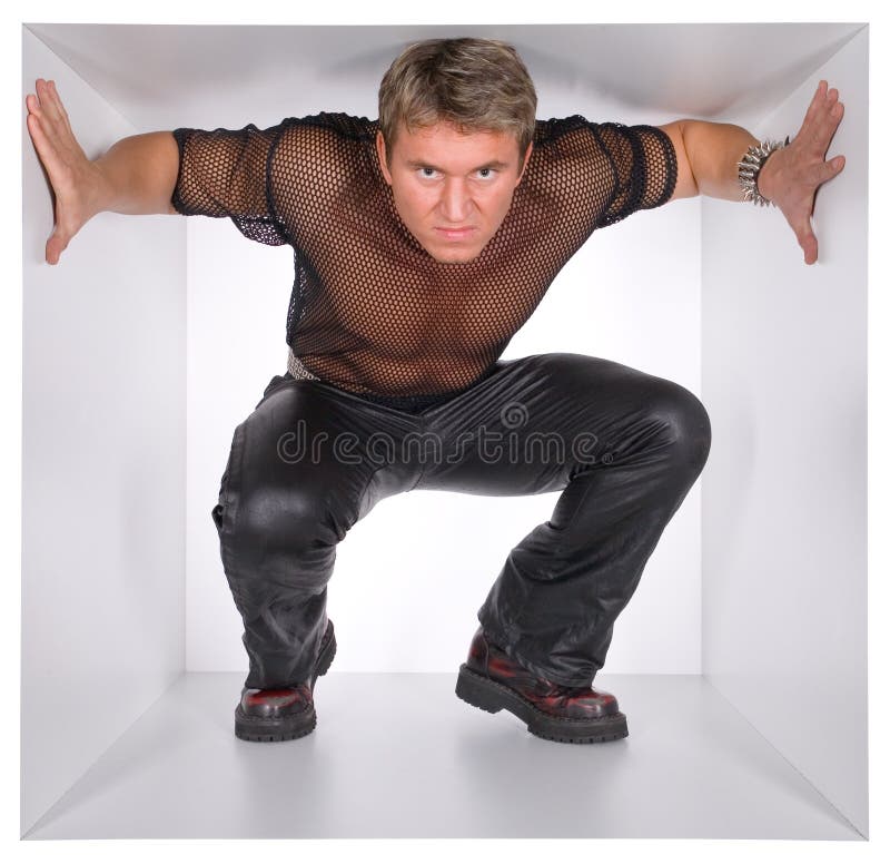 Muscular man in the white narrow cube. Muscular man in the white narrow cube