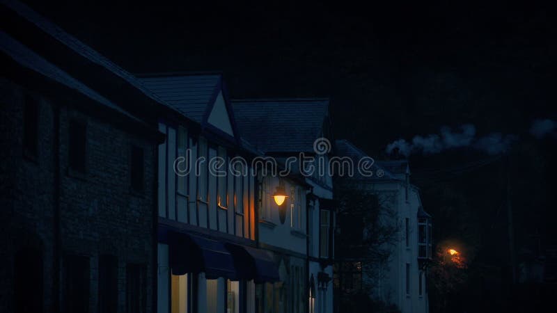 Village storefronts in the evening with smoking chimney