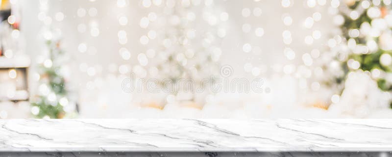 Christmas background of marble table top with abstract warm living room decor with christmas tree string light blur bokeh with snow,Holiday backdrop, panoramic Mock up banner for display of product. Christmas background of marble table top with abstract warm living room decor with christmas tree string light blur bokeh with snow,Holiday backdrop, panoramic Mock up banner for display of product