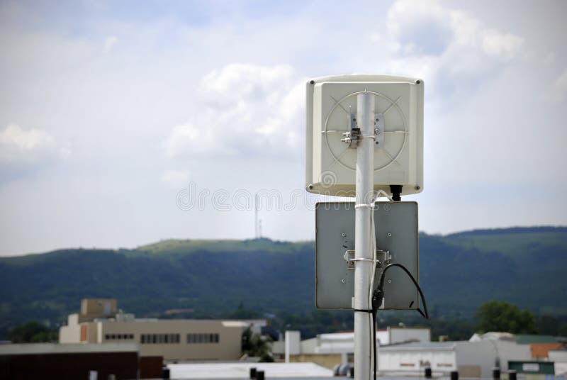 Wireless antennae pointing to transmitters on a distant hill. Slight vignette added to emphasize the antenna. Wireless antennae pointing to transmitters on a distant hill. Slight vignette added to emphasize the antenna.