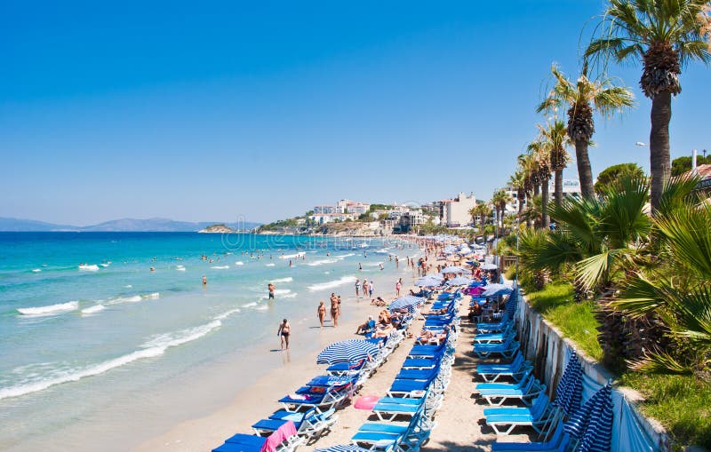 Ladies Beach, known in Turkish as Kadinlar Denizi, is one of the most popular and busiest beaches in Kusadasi. The name derived from the time the beach was segregated for female bathers only. Nowadays Ladies Beach is open to all and with a palm tree lined promenade full of shops, bars, cafes, restaurants and the many hotels. Ladies Beach, known in Turkish as Kadinlar Denizi, is one of the most popular and busiest beaches in Kusadasi. The name derived from the time the beach was segregated for female bathers only. Nowadays Ladies Beach is open to all and with a palm tree lined promenade full of shops, bars, cafes, restaurants and the many hotels.