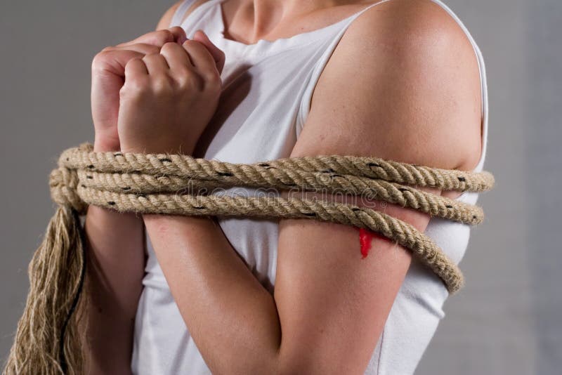 Tied lady on white shirt suggesting captivity. Tied lady on white shirt suggesting captivity