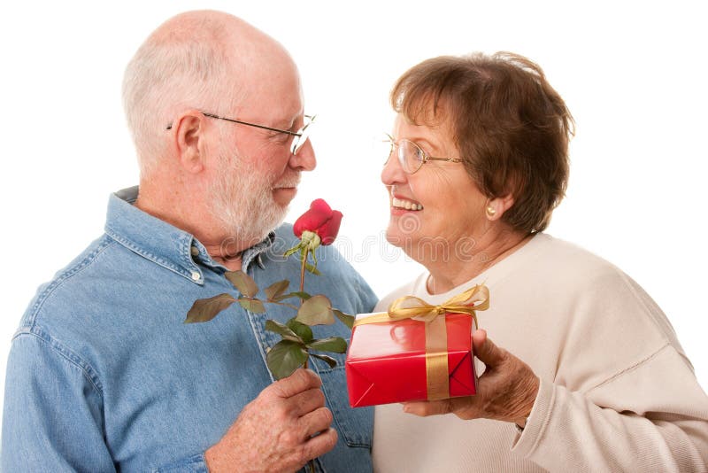 Happy Senior Couple with Gift and Red Rose Isolated on a White Background. Happy Senior Couple with Gift and Red Rose Isolated on a White Background.