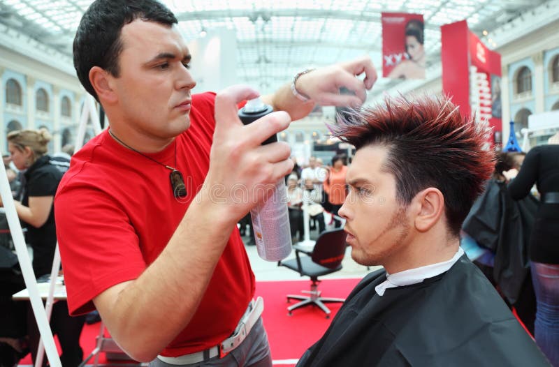 MOSCOW - OCTOBER 2: Hairdresser with hair spray makes hairstyle for man at XVII International Festival World of Beauty - 2010 in exhibition complex Gostiny Dvor, on October 2, 2010 in Moscow, Russia. MOSCOW - OCTOBER 2: Hairdresser with hair spray makes hairstyle for man at XVII International Festival World of Beauty - 2010 in exhibition complex Gostiny Dvor, on October 2, 2010 in Moscow, Russia.