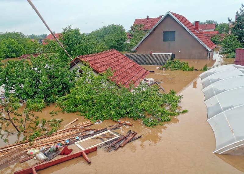 OBRENOVAC, SERBIA - MAY 16, 2014: House, and street in Obrenovac under water. The water level of Sava River remains high in worst flooding on record across the Balkans on may 16, 2014. OBRENOVAC, SERBIA - MAY 16, 2014: House, and street in Obrenovac under water. The water level of Sava River remains high in worst flooding on record across the Balkans on may 16, 2014