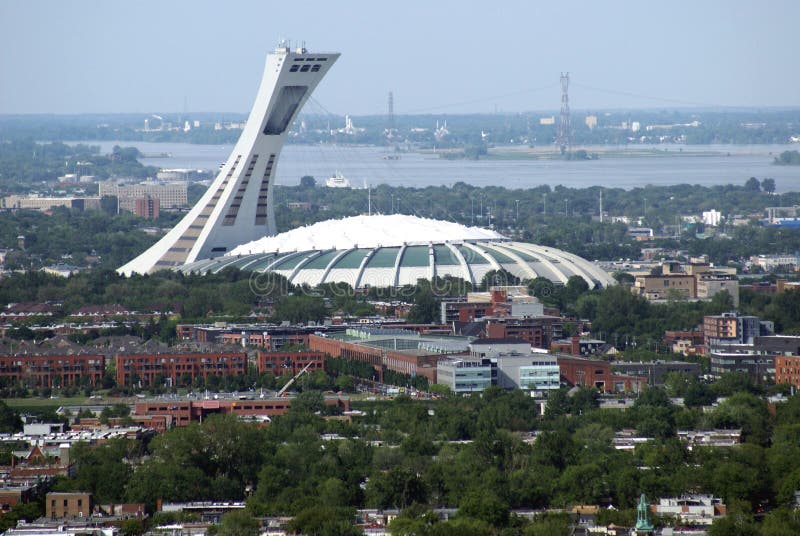 Aerial view of Montreal city and The Olympic Stadium or The Big O or The Big Owe, which is located at Olympic Park in the Hochelaga-Maisonneuve district of Montreal, Quebec, Canada. Aerial view of Montreal city and The Olympic Stadium or The Big O or The Big Owe, which is located at Olympic Park in the Hochelaga-Maisonneuve district of Montreal, Quebec, Canada.