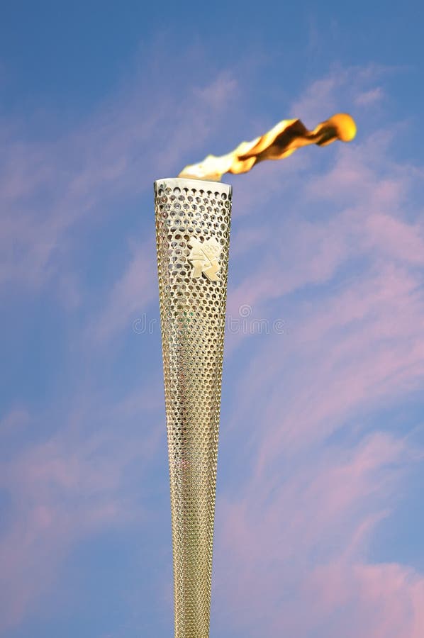 CAMBRIDGE, ENGLAND - JULY 7: Olympic flame burning at Parker's Piece in Cambridge during the Olympic Torch Relay ceremony. Close up of Olympic Torch showing the logo for London 2012 Olympic Games on July 7, 2012 in Cambridge. CAMBRIDGE, ENGLAND - JULY 7: Olympic flame burning at Parker's Piece in Cambridge during the Olympic Torch Relay ceremony. Close up of Olympic Torch showing the logo for London 2012 Olympic Games on July 7, 2012 in Cambridge