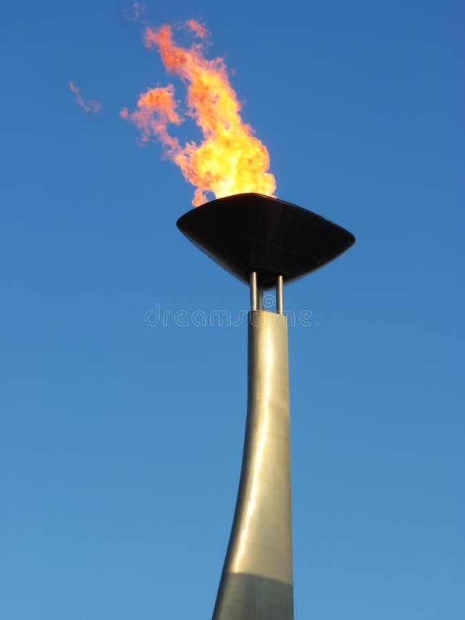 Olympic torch remembering Barcelona'92 anniversary. Close up of the flame over a blue sky. Olympic torch remembering Barcelona'92 anniversary. Close up of the flame over a blue sky