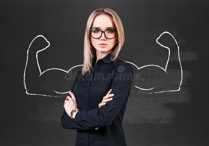 Business woman stands over chalkboard with drawn powerful hands. Business woman stands over chalkboard with drawn powerful hands.