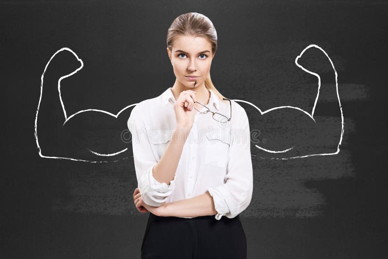 Business woman stands over chalkboard with drawn powerful hands. Business woman stands over chalkboard with drawn powerful hands.