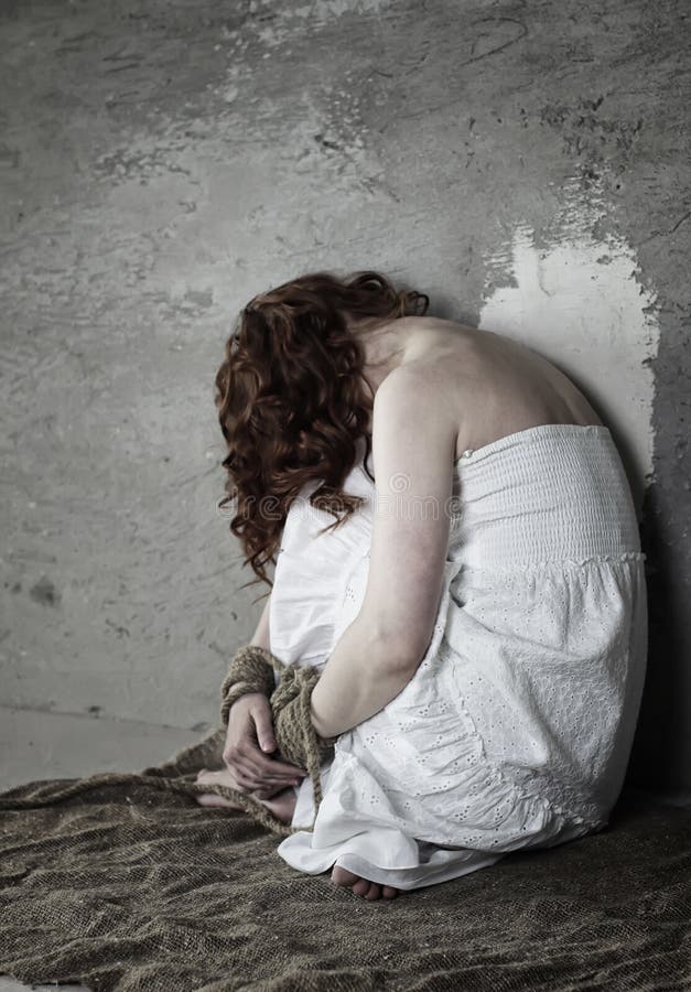 Portrait of a young red-haired girl on a background of gray plaster wall. Portrait of a young red-haired girl on a background of gray plaster wall