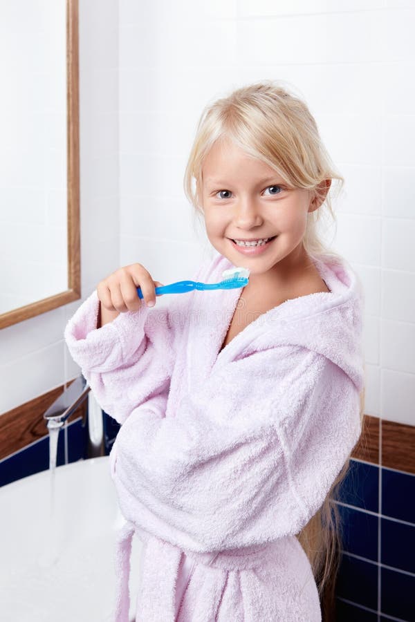 Girl brushing teeth in the bathroom. Girl brushing teeth in the bathroom