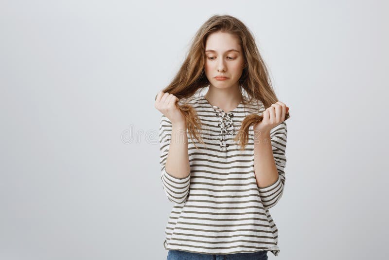 女孩是哀伤的她的坏头发子线 被分裂阴沉的被打扰的少妇的画象握头发和被弄翻, 免版税库存照片 女孩是哀伤的她的坏头发子线 被分裂阴沉的被打扰的少妇的画象握头发和被弄翻, 免版税库存照片