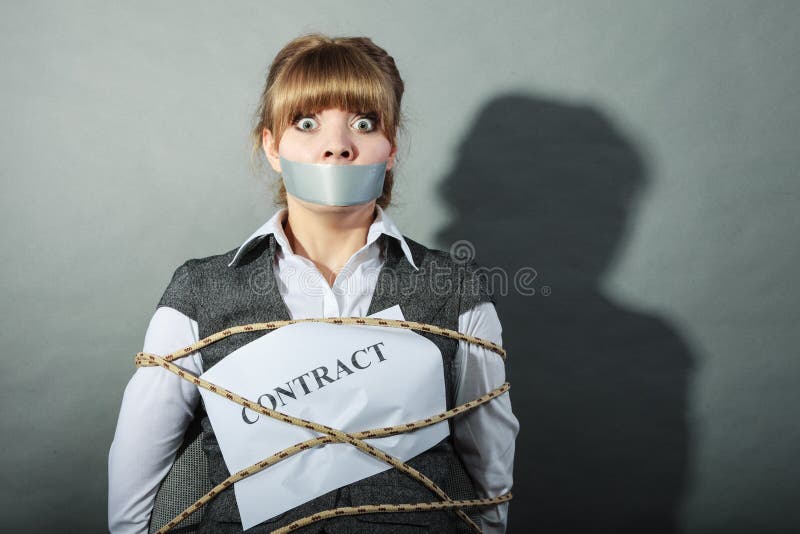 Afraid businesswoman bound by contract terms and conditions with mouth taped shut. Scared woman tied to chair become slave. Business and law concept. Afraid businesswoman bound by contract terms and conditions with mouth taped shut. Scared woman tied to chair become slave. Business and law concept.