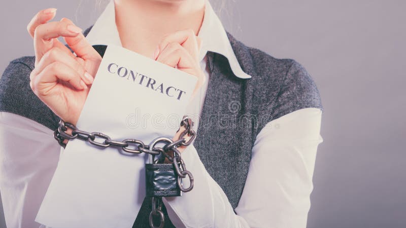 Business concept. businesswoman with chained hands holding contract. Business concept. businesswoman with chained hands holding contract