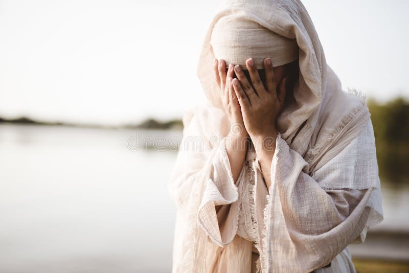 A closeup shot of a female wearing a biblical robe crying  - concept confessing sins. A closeup shot of a female wearing a biblical robe crying  - concept confessing sins
