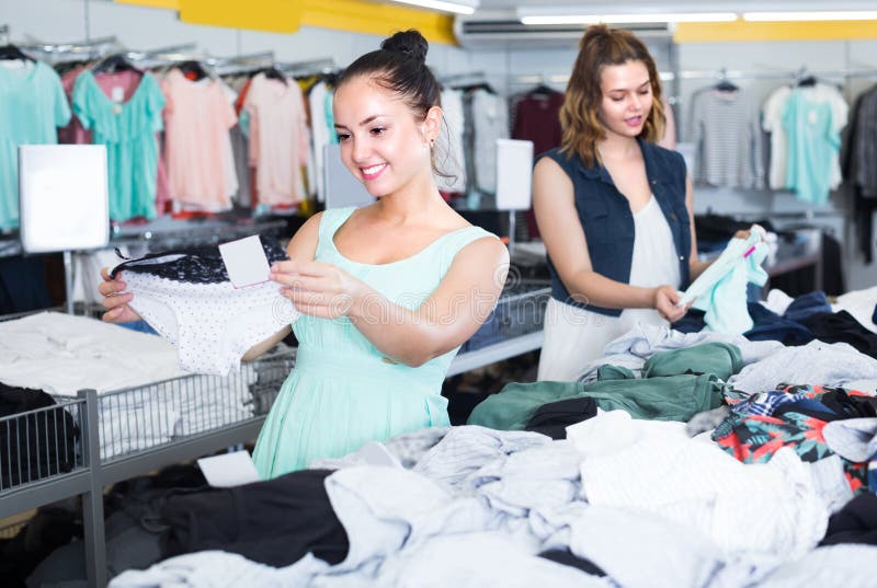 Women are choosing panties in underwear shop. Women are choosing panties in underwear shop.