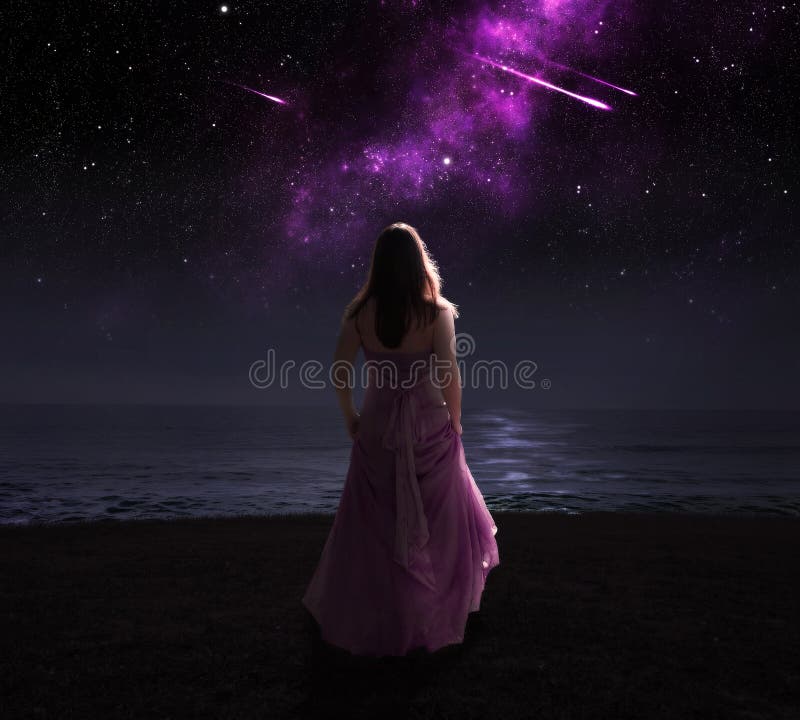 Woman standing in dress at night watching shooting stars. Woman standing in dress at night watching shooting stars.