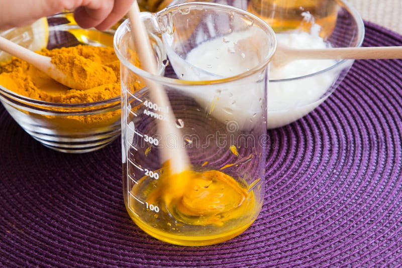 Preparation of the Turmeric face mask receipt set. Mix ingredients in a beaker. Ingredients: -1/2 teaspoon turmeric powder -½ teaspoon organic apple cider vinegar -one tablespoon of organic, raw, bee honey -½ teaspoon milk or yogurt -one drop lemon essential oil or fresh lemon juice for skin brightening effect. Preparation of the Turmeric face mask receipt set. Mix ingredients in a beaker. Ingredients: -1/2 teaspoon turmeric powder -½ teaspoon organic apple cider vinegar -one tablespoon of organic, raw, bee honey -½ teaspoon milk or yogurt -one drop lemon essential oil or fresh lemon juice for skin brightening effect