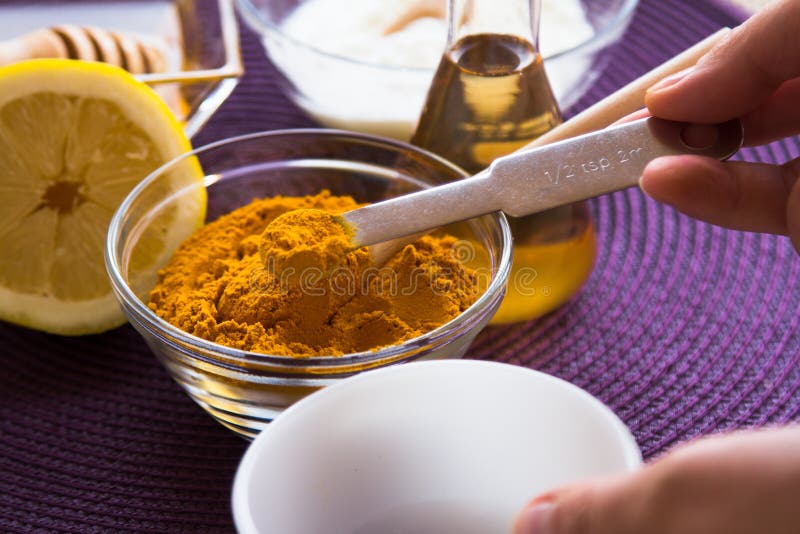 Preparation of the Turmeric face mask receipt set. Add turmeric powder in a small bowl. Ingredients: -1/2 teaspoon turmeric powder -½ teaspoon organic apple cider vinegar -one tablespoon of organic, raw, bee honey -½ teaspoon milk or yogurt -one drop lemon essential oil or fresh lemon juice for skin brightening effect. Preparation of the Turmeric face mask receipt set. Add turmeric powder in a small bowl. Ingredients: -1/2 teaspoon turmeric powder -½ teaspoon organic apple cider vinegar -one tablespoon of organic, raw, bee honey -½ teaspoon milk or yogurt -one drop lemon essential oil or fresh lemon juice for skin brightening effect