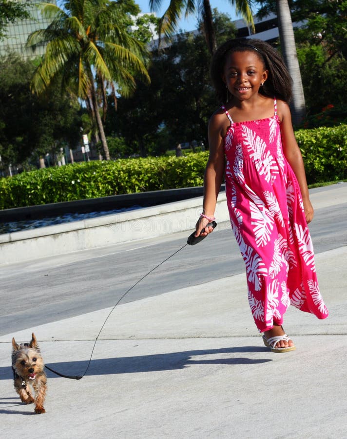 Young child walking her dog. Young child walking her dog.