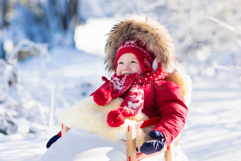 孩子的雪撬和雪乐趣 婴孩sledding在冬天公园 库存图片