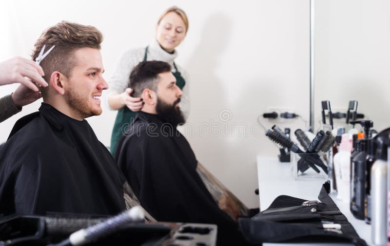 Adult male having their hair cut by hairdressers at hair salon. Adult male having their hair cut by hairdressers at hair salon