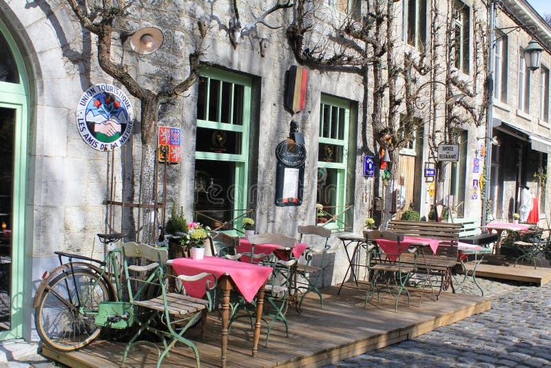 An outdoor little restaurant in Durbuy, Belgium. Few tables with chairs outside, on the open air. Durbuy is a Walloon city and municipality located in the Belgian province of Luxembourg. Tourism and recreation are its main activities nowadays. Durbuy is often presented and promoted as `the smallest city of the world`. An outdoor little restaurant in Durbuy, Belgium. Few tables with chairs outside, on the open air. Durbuy is a Walloon city and municipality located in the Belgian province of Luxembourg. Tourism and recreation are its main activities nowadays. Durbuy is often presented and promoted as `the smallest city of the world`.