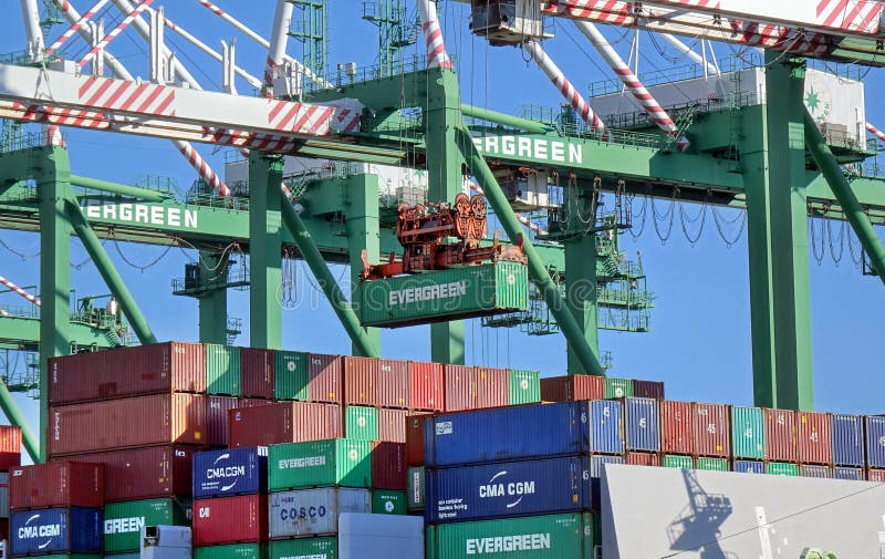 KAOHSIUNG, TAIWAN -- JUNE 2, 2019: Containers are being loaded onto ships in Kaohsiung Port. KAOHSIUNG, TAIWAN -- JUNE 2, 2019: Containers are being loaded onto ships in Kaohsiung Port