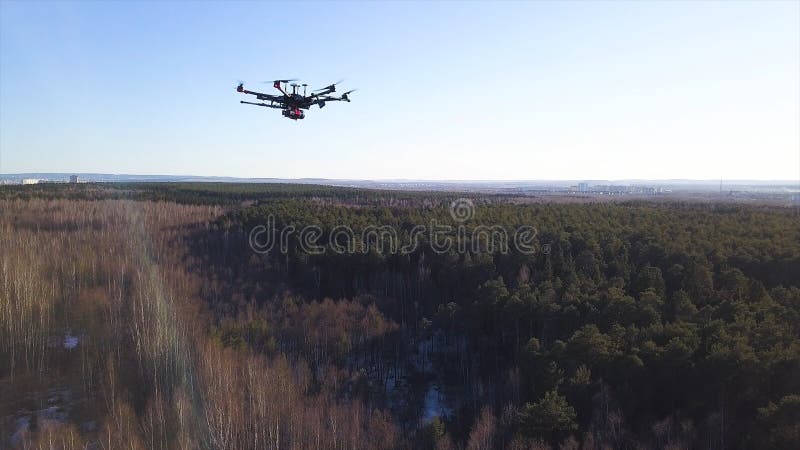 Aerial for the drone camera flying in the sky above deciduous and coniferous forest on blue sky background. Spinning quadcopter blades, slow motion. Aerial for the drone camera flying in the sky above deciduous and coniferous forest on blue sky background. Spinning quadcopter blades, slow motion.